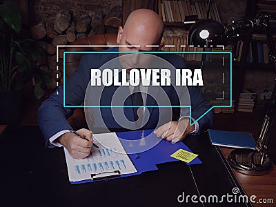 Individual Retirement Accounts ROLLOVER IRA phrase on the screen. Auditor checking financial report AÂ rollover IRAÂ Â is a Stock Photo